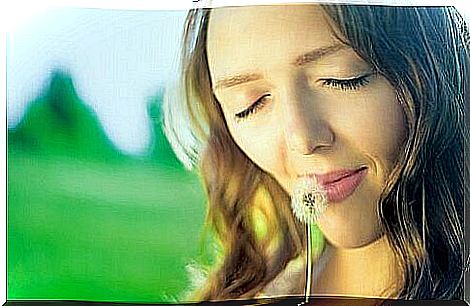 Woman smelling dandelion