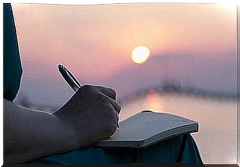 One person writes diary at sunset