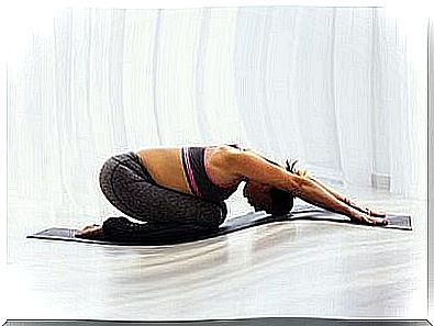 A woman does yoga in the morning.