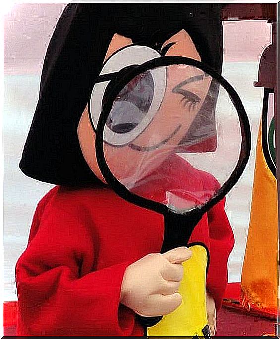 Girl looking in magnifying glass