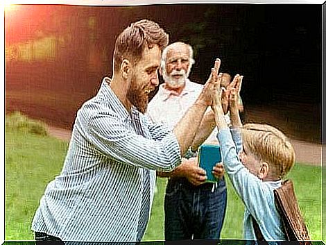 A man who gives a high five to a child.