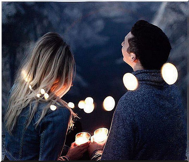 couple surrounded by candles holding tealights