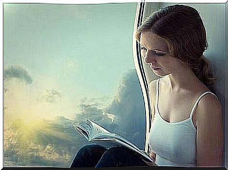 girl-reading-book-by-a-window