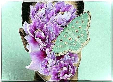 Woman with flower and butterfly on her face