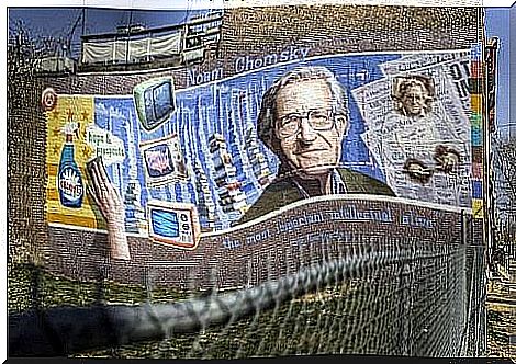 Graffiti by noam chomsky on a wall