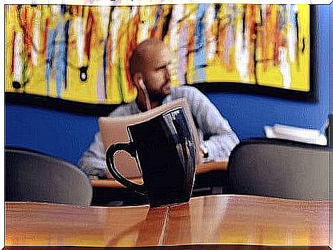 A guy at a coffee shop working on his computer