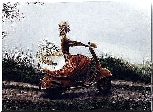 A woman on a scooter with a fish ball