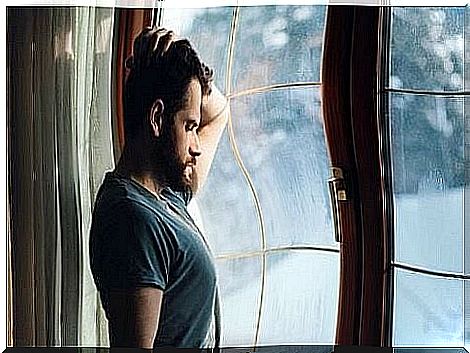 man looking out of a window