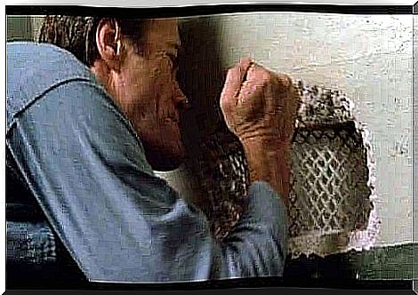 Clint Eastwood digs holes in the wall.