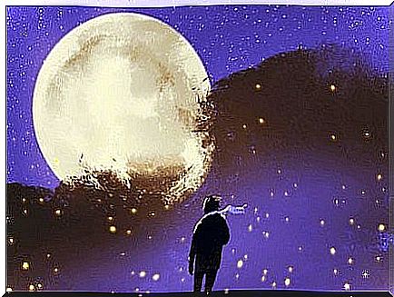 A guy with a scarf looking at the moon