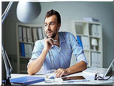 A man thinking at his desk.