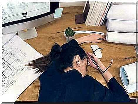 A woman sleeping on her desk.