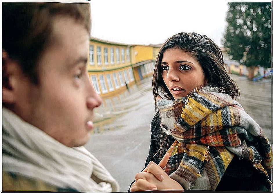 A man and a woman talking together.