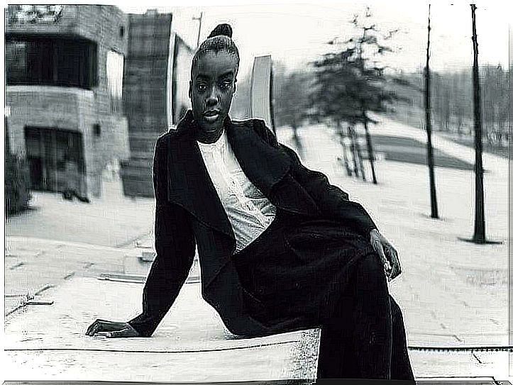 woman sitting on the sidewalk